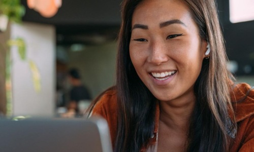 Find your perfect fit at Broadstone Sierra Vista a woman smiling while working on laptop