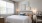 a bedroom with a bed and a chair