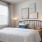 a bedroom with a bed and a chair