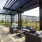 pergola shaded sitting area next to pool