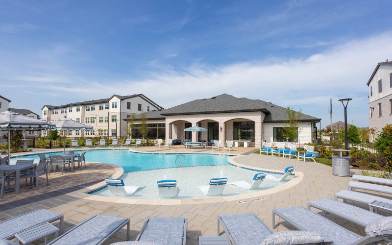 Settle into comfort at Broadstone Sierra Vista lounge chairs surround pool