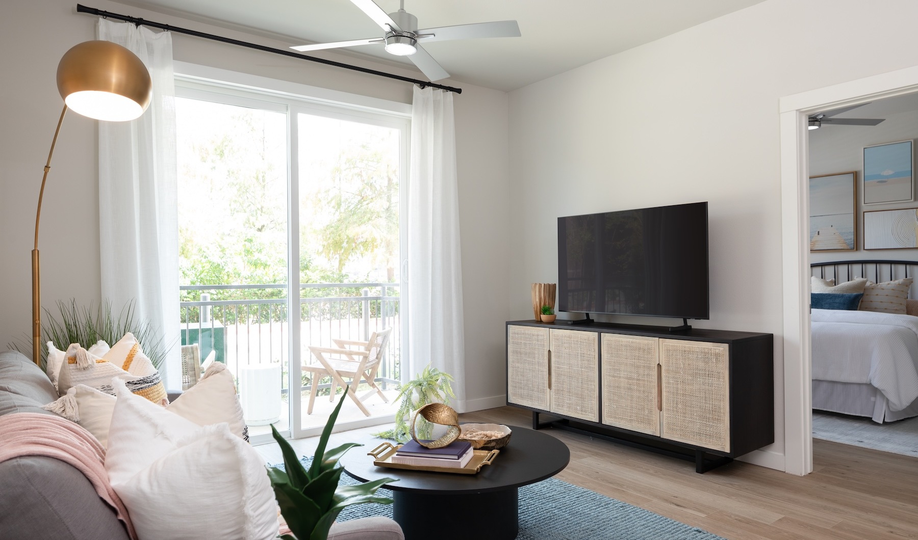 living room with a couch coffee lamp table and a tv