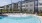 a pool with chairs around it