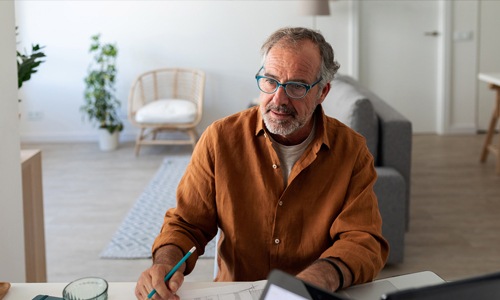The essence of exceptional living a man sitting at a table writing on a piece of paper