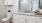 a bathroom with white cabinets