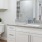 a bathroom with white cabinets