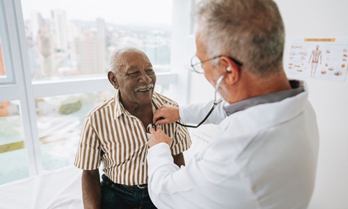 The essence of exceptional living a doctor checking a older man's heart
