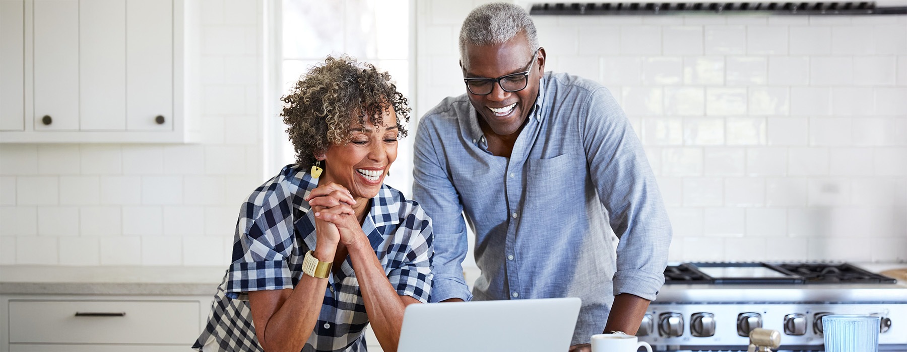a man and a woman looking at a laptop